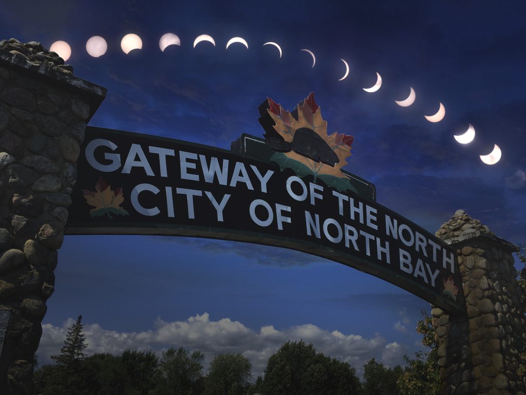Zack Lewis solar eclipse composite with Gateway of the North sign City of North Bay, Ontario - April 8, 2024